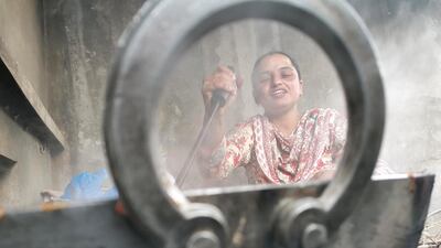 Harvinder Kaur, 33, often joins in Amandeep Singh to help her in household chores, especially cooking for the family as Amandeep Singh juggles between tending to her husband's crops and livestock.