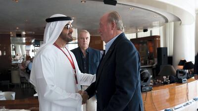 Sheikh Mohammed bin Zayed, Crown Prince of Abu Dhabi and Deputy Supreme Commander of the UAE Armed Forces, greets Juan Carlos I, former King of Spain, at Cipriani restaurant on the second day of the Formula 1 Etihad Airways Abu Dhabi Grand Prix. They are seen with Prince Andrew, Duke of York, back centre. Mohamed Al Hammadi / Crown Prince Court - Abu Dhabi
