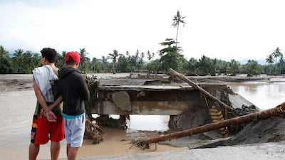 Filipino villagers view a damaged bridge in flood-hit town of Salvador, Lanao del Norte province, Philippines, on December 23, 2017. Jeoffrey Maitem / EPA