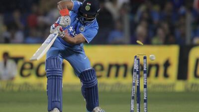 India's Suresh Raina is clean bowled by Sri Lanka's Dasun Shanaka during their first Twenty20 cricket match in Pune, India, Tuesday, Feb. 9, 2016. (AP Photo/Rajanish Kakade)