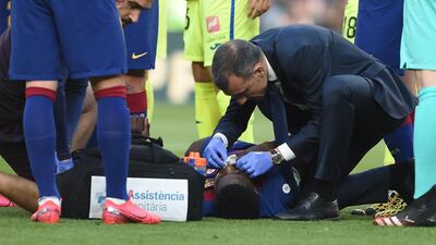 Barcelona's Samuel Umtiti receives medical attention. AFP