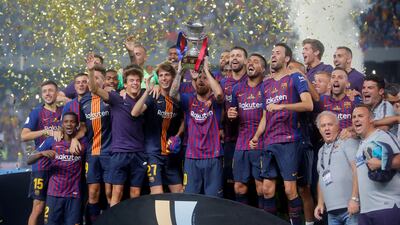 Barcelona's Lionel Messi, the new captain of the team, lifts the trophy. Reuters