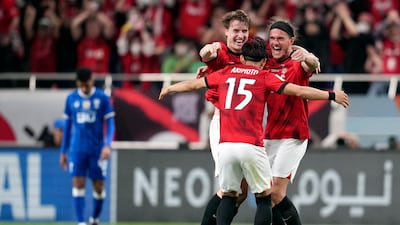 Marius Hoibraten, left, Alexander Scholz, right, and Takahiro Akimoto, centre, celebrate after Urawa Red Diamonds win the Asian Champions League final with a 2-1 aggregate victory over Al Hilal. AP