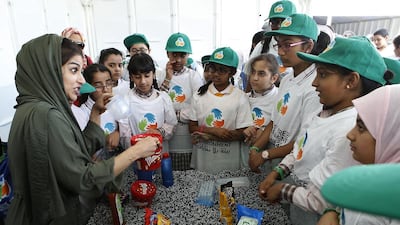 Pupils learn about plastics and littering at a beach clean-up campaign. Ravindranath K / The National