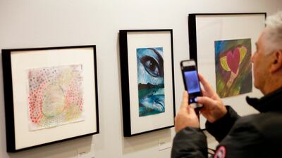 Artwork made by detainees of the Guantanamo Bay camp on show at an exhibit at at the John Jay College of Criminal Justice in New York, including a piece, far left, by Ammar Al Baluchi. AP