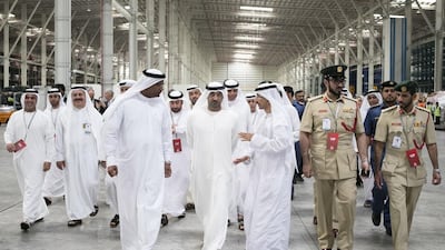 Sheikh Ahmed Al Maktoum, centre, chairman and chief executive of Emirates Airline and Group, inaugurated the new cargo terminal. He was given a tour by Nabil Sultan, left, Emirates Divisional senior vice president, Cargo. Reem Mohammed / The National