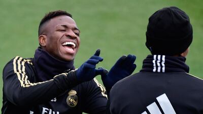 Real Madrid's Brazilian forward Vinicius Junior (L) and defender Eder Militao joke during a training session at the Real Madrid City sports facility in Madrid. AFP
