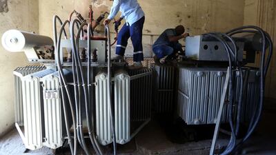 Employees of the General Electricity Company repair power converters in the Libyan capital Tripoli. AFP