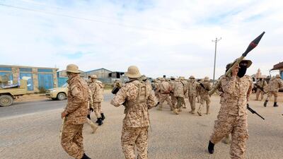 Members of the Tripoli Protection Force, an alliance of militias from the capital city, patrol an area south of the Libyan capital. Mahmud Turkia / AP
