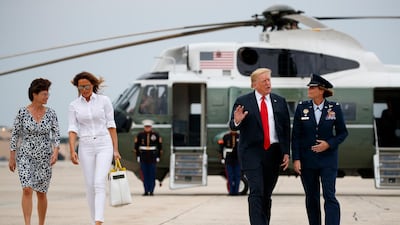 President Donald Trump and first lady Melania Trump walk to board Air Force One, Friday, July 27, 2018. AP