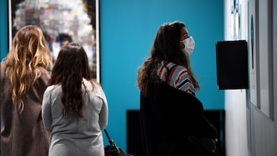 People wearing protective masks visit the Museum of Illusion in Paris. AFP