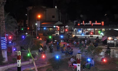A general view shows an outdoors coffee shop in Hafez al-Assad square, named after the late Syrian president and the father of the current ruler, in Syria's northeastern city of Hasakeh on June 11, 2018 Ayham Al Mohammad / AFP