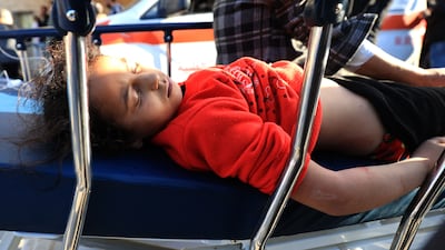 A Palestinian girl on a gurney after being injured at Al Maghazi refugee camp. AFP