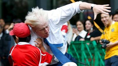 London's Mayor Boris Johnson collides with 10-year-old Toki Sekiguchi during a game of Street Rugby with a group of Tokyo children on Thursday. Issei Kato / Reuters / October 15, 2015