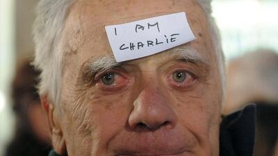 A man with a sticker “I am Charlie” on his forehead takes part in a gathering at the French Institute in Belgrade on January 8, 2015 to pay tribute to the twelve people killed the day before in an attack by two armed gunmen on the offices of French satirical weekly Charlie Hebdo in Paris. A stunned and outraged France is in mourning, as security forces desperately hunt two brothers suspected of gunning down 12 people in an Islamist attack on the satirical weekly. Alexa Stankovic / AFP photo