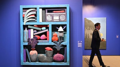 A man walks past an artwork named "Wooden Wood 40, 2023" by artist Yuichi Hirako during the Frieze Seoul 2023 art fair in Seoul on September 6, 2023. (Photo by Jung Yeon-je / AFP) / RESTRICTED TO EDITORIAL USE - MANDATORY MENTION OF THE ARTIST UPON PUBLICATION - TO ILLUSTRATE THE EVENT AS SPECIFIED IN THE CAPTION