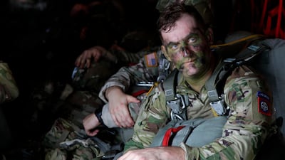 In this Jan. 26, 2020, photo, Sgt Micah Jurekovic waits for takeoff inside a C-130 Hercules transport plane with dozens of other 82nd Airborne Division paratroopers. AP