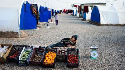 A young vegetable vendor rests at the Khazer refugee camp, for displaced people who fled the violence in the Islamic State (IS) group stronghold of Mosul, near the Kurdish checkpoint of Aski kalak, 40 km West of Arbil, the capital of the autonomous Kurdish region of northern Iraq. Dimitar Dilkoff / AFP