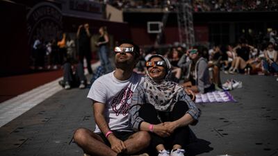 Visitors watch the eclipse move into totality in Bloomington. Bloomberg