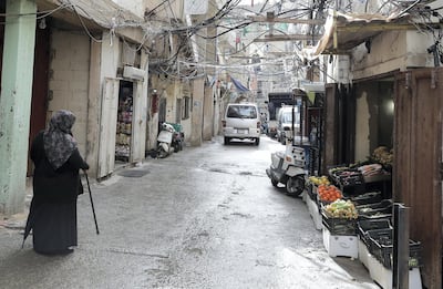 A Palestinian woman walks down the street in the Burj Al Barajneh camp in the Lebanese capital. JOSEPH EID / AFP