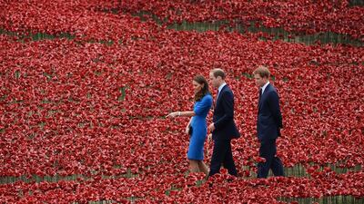 Catherine, Duchess of Cambridge, Prince William, Duke of Cambridge and Prince Harry walk through a sea of red poppies inside the moat at the Tower of London. The Tower of London moat has turned turning red as some 888,246 ceramic poppies are planted in memory of the British and Commonwealth dead from World War One. Andu Rain / EPA