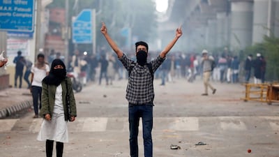 Protestors shout slogans during a protest against the Citizenship Amendment Bill, a bill that seeks to give citizenship to religious minorities persecuted in neighbouring Muslim countries, outside the Jamia Millia Islamia University in New Delhi. Reuters