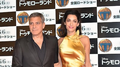 George and Amal Clooney, wearing marigold silk by Maison Margiela, at the premiere of 'Tomorrowland' on May 25, 2015 in Tokyo, Japan. Getty Images