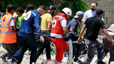 Rescuers evacuate the body of a victim from the site of an Israeli air strike on the town of Qennarit in southern Lebanon. EPA