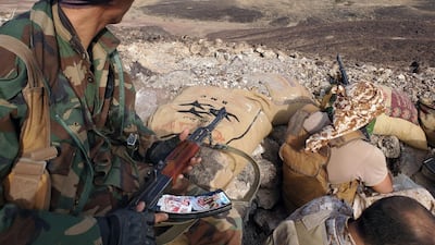 Fighters loyal to Yemen's government man a position near the front line in Marib province. AFP