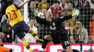 Arsenal's Andrey Arshavin scores his fourth goal past Liverpool goalkeeper Jose Reina.