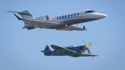 A Learjet 75 (top) and a Second World War Spitfire during the 100th anniversary celebrations at London Biggin Hill Airport this week. Learjet maker Bombardier's losses have widened. Leon Neal / Getty