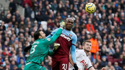 Tottenham Hotspur's Eric Dier in action with West Ham United's Roberto and Angelo Ogbonna. Reuters