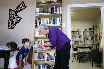 Nancy talks to children visiting her library Books and More in Amman, Jordan. (Salah Malkawi for The National)