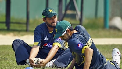 Pakistan’s Shahid Afridi, left, and Umar Gul stretch during a team practice session in Dhaka, Bangladesh, on March 7, 2014. AM Ahad / AP Photo