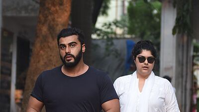 Actor Arjun Kapoor and his sister attend the funeral of Krishna Raj Kapoor. AFP