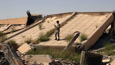 An Iraqi soldier taking a photo of the tomb of Iraq's late dictator Saddam Hussein, which was virtually levelled in heavy clashes between militants from the ISIL group and Iraqi forces on Sunday as both sides fight for control of Tikrit. Khalid Mohammed/AP Photo