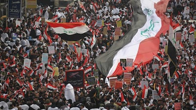 Thousands of Iraqis, waving national flags, take to the streets in central Baghdad. AFP