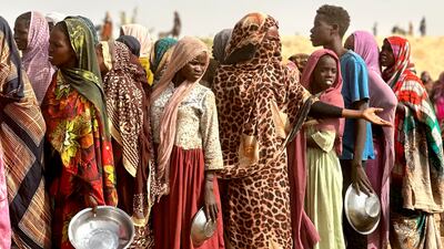 Sudanese refugees from the Zamzam camp, after it fell under the control of the Rapid Support Forces, queue for food near the town of Tawila in Sudan's western Darfur region. AFP
