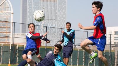 Westminster School, in blue tops, take on Dubai National School at Sports City, Dubai, in the Dubai Schools Football Cup. The semi-final, final and awards ceremony will take place this weekend. Duncan Chard for The National