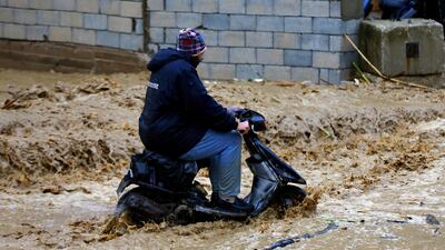 A man drives on a scooter on a flooded street in Beirut. AP Photo