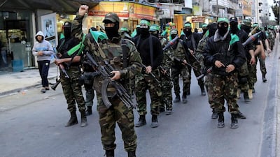 Palestinian masked militants of the Ezzedine Al Qassam Brigades, Hamas' military wing, take part in a parade in Gaza to mark the 11th anniversary of the Israeli assassination of Hamas spiritual leader, Sheikh Ahmad Yassin, on March 23, 2015. Adel Hana, File/AP Photo