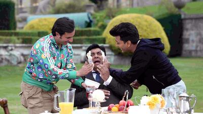 Saif Ali Khan, left, and Riteish Deshmukh, right, give Ram Kapoor a butter facial in a scene from Humshakals. Courtesy Puja Films