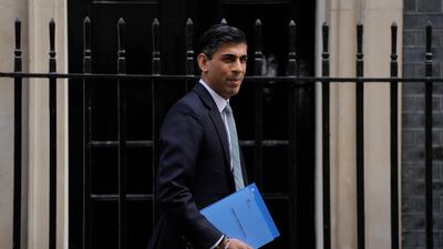 Rishi Sunak, Britain's Chancellor of the Exchequer, poses for the media as he leaves 11 Downing Street in London. AP