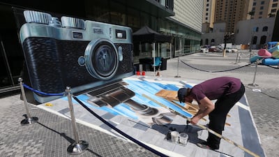 Artist Leon Keer paints his 3D piece. Pawan Singh / The National