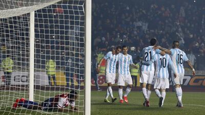 Argentina's players celebrate after Angel Di Maria, centre, scored their fourth goal in the Copa America semi-final against Paraguay. Silvia Izquierdo / AP
