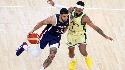 Jayson Tatum of USA takes on Patty Mills of Australia.