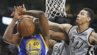 Kawhi Leonard and Danny Green of the Spurs block Harrison Barnes of the Warriors during their NBA game on Saturday night. Ronald Cortes / Getty Images / AFP / March 19, 2016