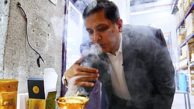 Nader Adam Ali, director of Swiss Arabian, burning bakhoor at one of its factories in Sharjah. All photos by Pawan Singh / The National