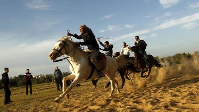 Palestinian men ride their horses as they compete in a local race in the southern Gaza Strip town of Khan Yunis. Said Khatib / AFP