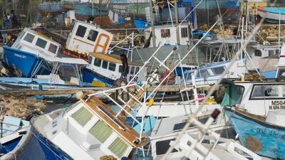 A fisherman looks at boats damaged by Hurricane Beryl at Bridgetown Fisheries in Barbados. AP